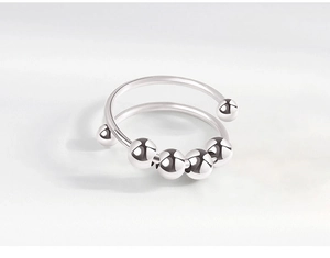 Close-up of silver anti-anxiety ring with movable beads and open band design