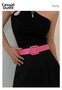 Detail of hot pink wide waist belt with square buckle worn on black dress