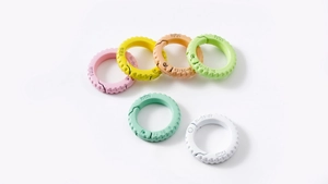 Close-up of matte colorful alloy spring rings and tire-shaped round keyrings for DIY