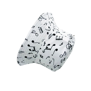 Detail of white bucket hat featuring black musical notes and treble clef printed pattern