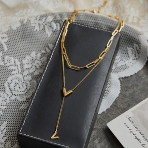 Double-layered 18K gold plated titanium steel V-pendant necklace on black leather case
