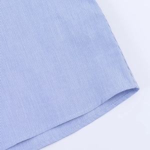 Detailed macro view showing blue and white striped poplin fabric and hem stitching