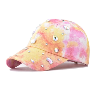 Detail of pink tie-dye baseball cap with colorful rhinestones in a 45-degree side view