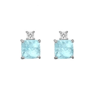 Macro shot of silver stud earrings with square light blue gemstone and zircon stone