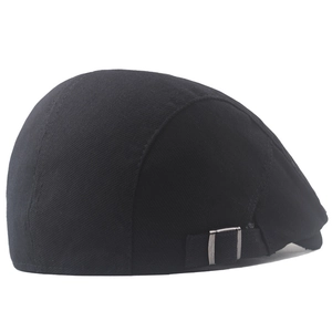 Detail view of black beret cap showing twill fabric texture and metal adjustment buckle
