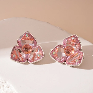 Macro shot of pink clover gemstone earrings with silver twisted rope edge detail