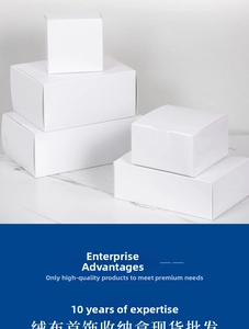 Stack of minimalist matte white jewelry gift boxes on a light marble surface