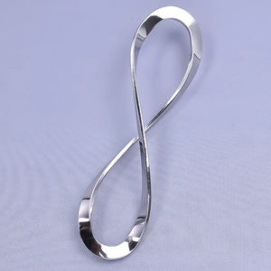 Macro shot of silver 304 stainless steel infinity symbol pendant with a mirror-finish surface