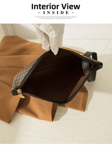 Macro view of the large capacity dark brown handbag interior with premium metal zipper