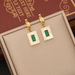 Golden emerald emerald necklace with square pendants displayed in a beige jewelry box