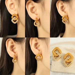 Collection of geometric gold earrings with pearls and rhinestones shown on a model