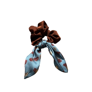 Elegant contrast bow scrunchie featuring dark brown satin and printed blue ribbon