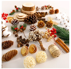 Flat lay of natural pine cones, cotton balls, red berries and cinnamon for DIY Christmas decor