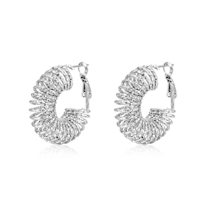 Vintage silver titanium steel spiral hoop earrings with diamond-cut texture on white background