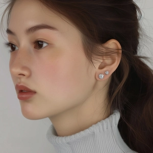 Elegant S999 sterling silver stud earrings with sparkling cubic zirconia on female model
