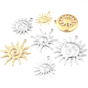 Set of gold and silver sun and moon stainless steel pendants on a white background