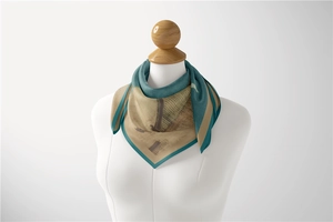 Detail of artistic Van Gogh style silk scarf tied elegantly on a mannequin bust