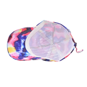 Detail view of colorful tie-dye baseball cap interior with mesh lining and metal buckle