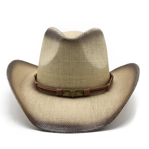 Detail view of woven straw cowboy hat with gradient spray paint and skull ornament