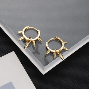 Macro shot of 18K gold-plated spike hoop earrings with pavé cubic zirconia details