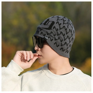 Detail of gray knitted beanie with black jacquard lettering and warm fleece lining