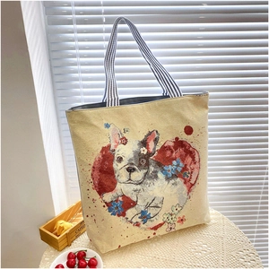 Detail shot of canvas tote bag featuring French Bulldog print and floral heart patterns