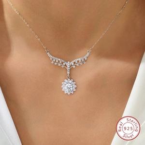 925 sterling silver sunflower necklace with moissanite wings pendant on a female model
