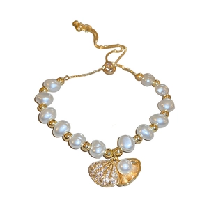 French style baroque pearl bracelet with gold beads and a sparkling zircon shell charm