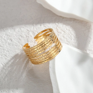 Minimalist gold multi-layer open ring with hammered texture in a professional macro shot