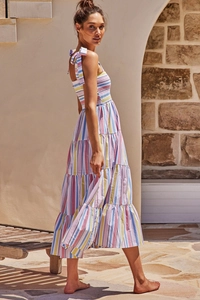 Detail of colorful striped tiered maxi dress with bow straps and smocked bodice detail
