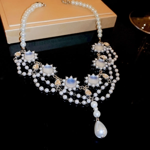 Detailed macro shot of vintage court style necklace with blue gemstones and white pearls