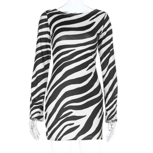 Close-up of zebra print fabric texture on a slim-fit backless mini dress with long sleeves