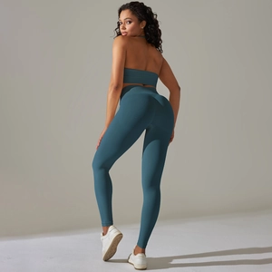 Detail of teal ribbed seamless yoga set showing high-waist leggings and sports bra texture