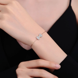 Sparkling zircon heart bracelet in rose gold finish shown on a woman's wrist