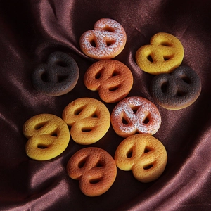 Macro shot of assorted resin pretzel charms in various shades of brown for DIY crafts