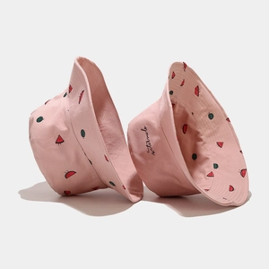 Close-up of pink cotton bucket hat with cute watermelon prints and cursive embroidery