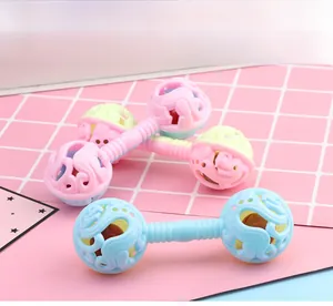 Close-up of macaron color dumbbell rattles with hollow texture and easy-grip handles