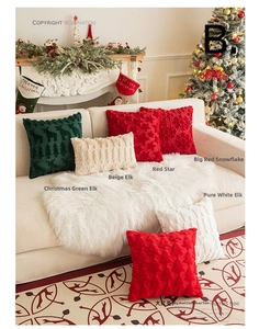 Close-up of plush Christmas pillows with embroidered snowflakes and trees on a sofa