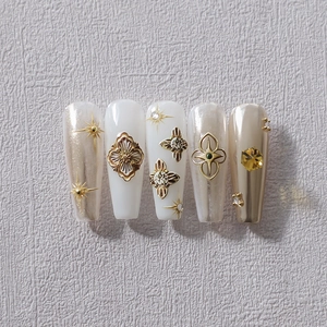 Luxury pearl white and gold embossed star press-on nails in medium trapezoid shape