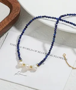 Detail of blue natural stone beaded necklace with baroque pearls and gold hardware