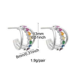 Macro detail of silver C-shaped stud earrings with rainbow zircons showing 13mm height