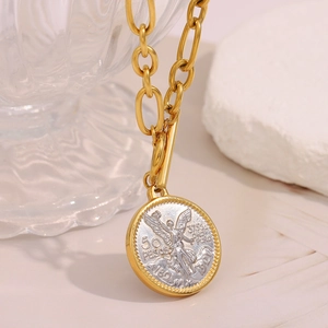 Macro shot of gold T-bar chain with two-tone silver and gold angel coin pendant