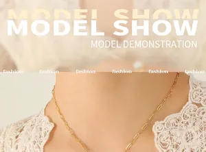 Detailed view of the 18K gold plated paperclip chain necklace on a model's collarbone