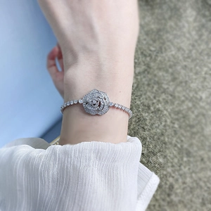 Close-up of S925 silver flower bracelet with sparkling cubic zirconia on a wrist