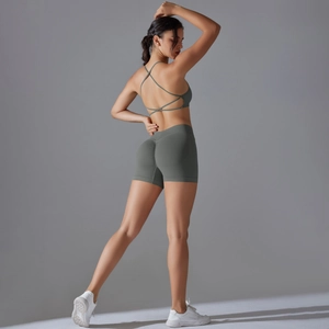 Detail of the cross-back sports bra and high-waisted scrunch butt lifting yoga shorts