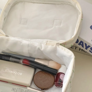 Large capacity minimalist floral cosmetic bag for travel storage shown with cosmetics