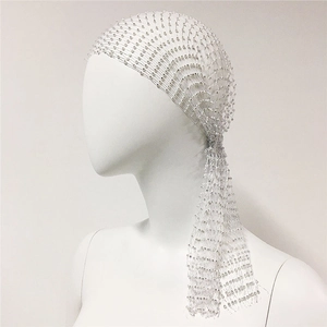 Macro detail of white mesh headpiece with sparkling rhinestone beads and elegant long ribbons
