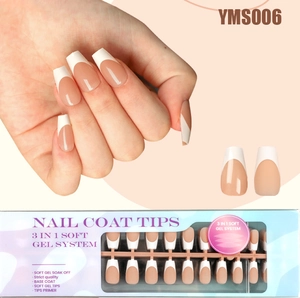 Detail of French tip press-on nails with soft gel finish in retail packaging