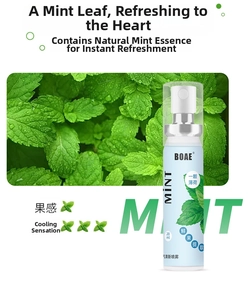 Close-up of 20ml mint oral spray bottle with fresh green peppermint leaves background