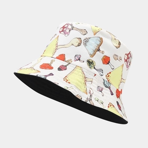 Detail of reversible bucket hat with colorful mushroom print and black inner fabric side